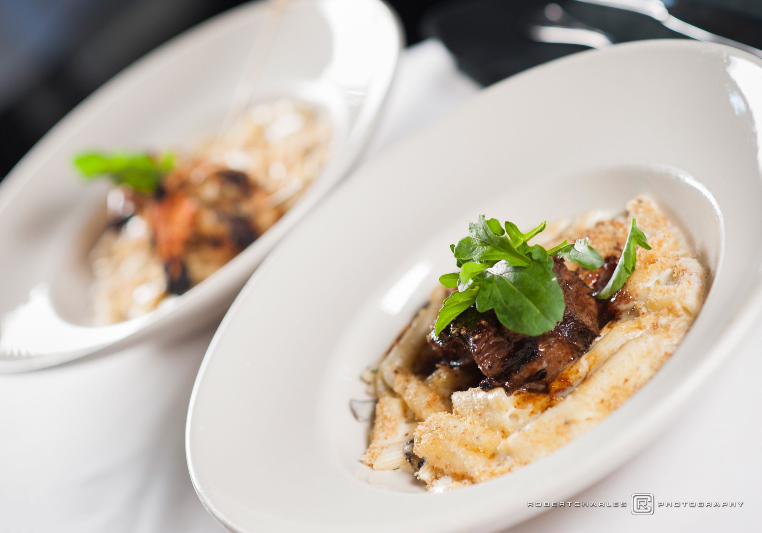 Plated short rib over creamy pasta